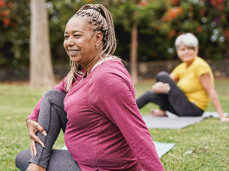 Multi-racial women doing yoga in a park